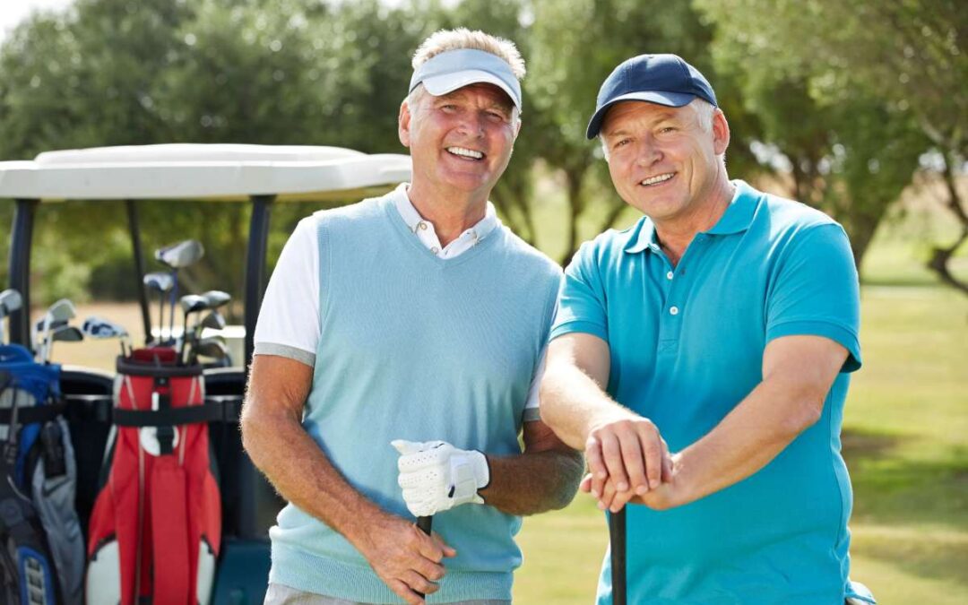 two seniors holding golf sticks in front of a golf cart